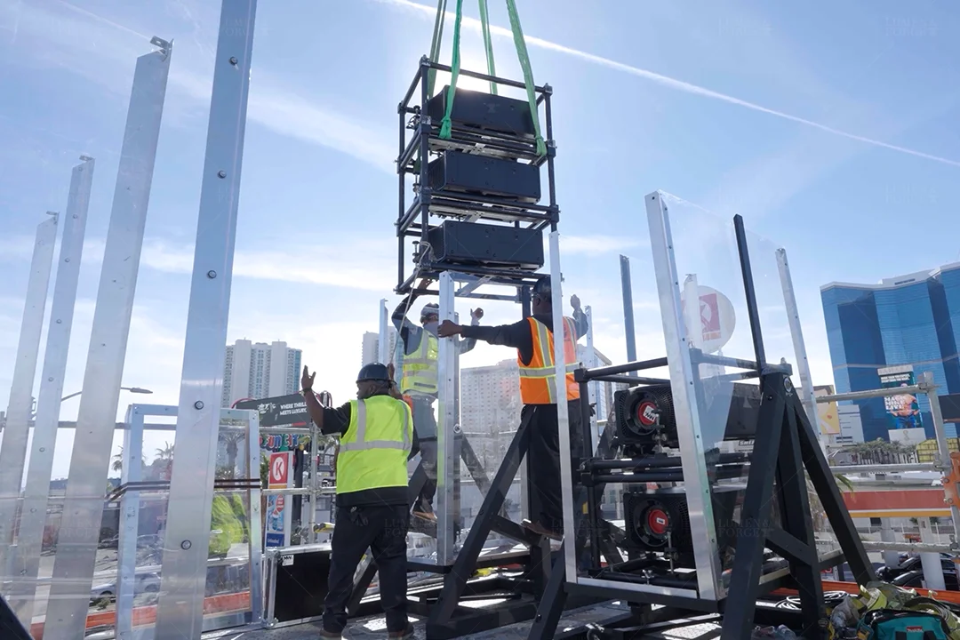 High-output Panasonic projector being installed inside a custom outdoor enclosure