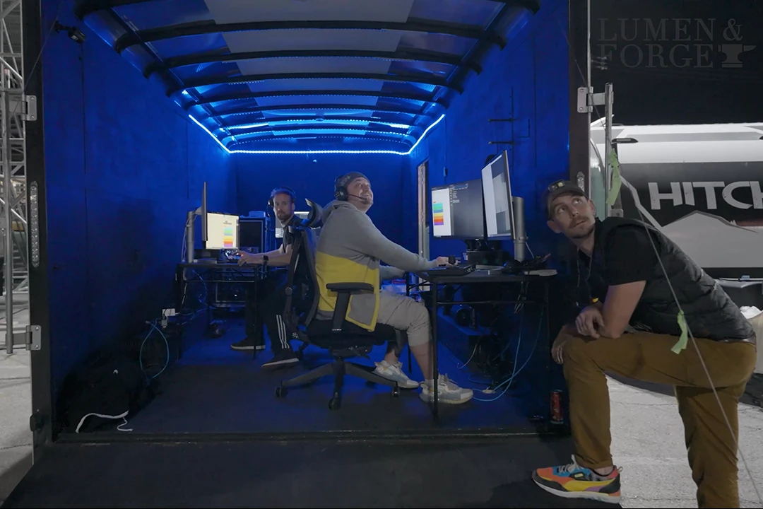 Morgan Lavery in a yellow and gray sweater programming the networked Stratosphere projection system onsite