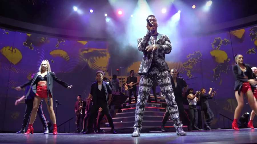 Celebrity Edge performance surrounded by panoramic show visuals