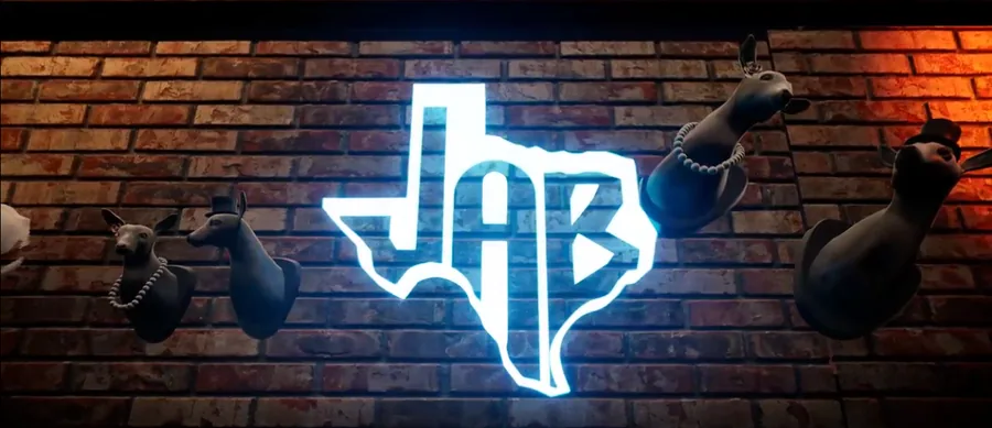 Closeup of glowing JAB logo on a brick dive bar wall with mounted birds