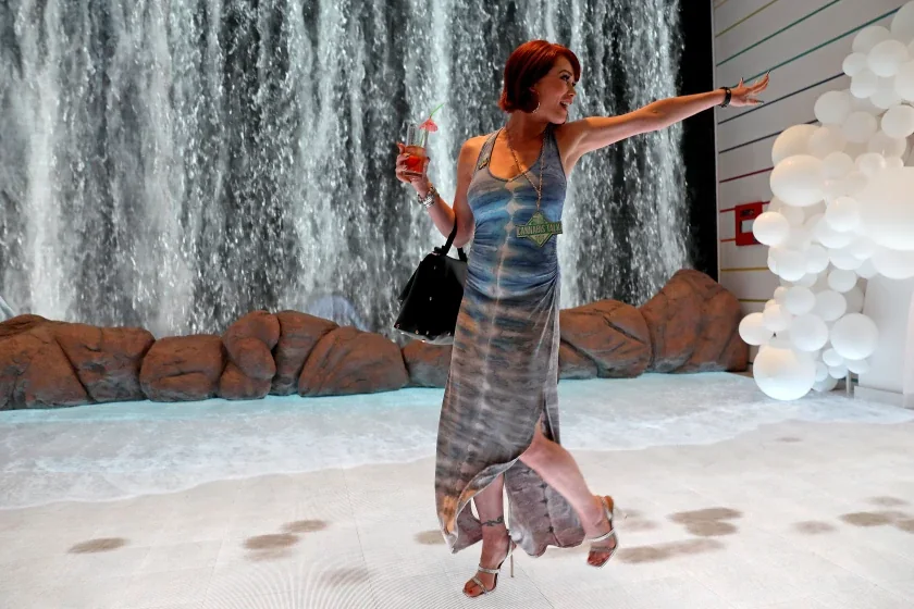 Guest walking across the interactive beach floor with visible digital footprints