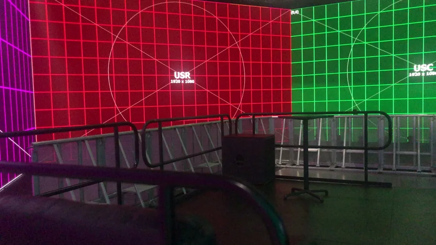 Red and green LED wall sections with barricades in the foreground