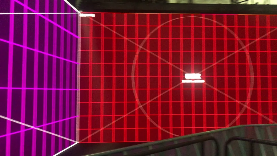 Magenta and red LED walls wrapping around a pentagon corner