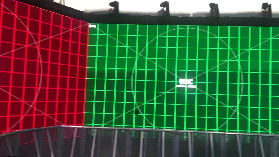 Red and green LED walls with grid alignment across adjacent panels