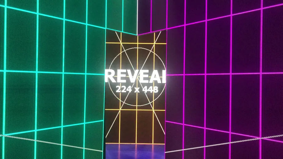 Physical LED wall mapping test with teal and magenta grid surfaces and center reveal panel