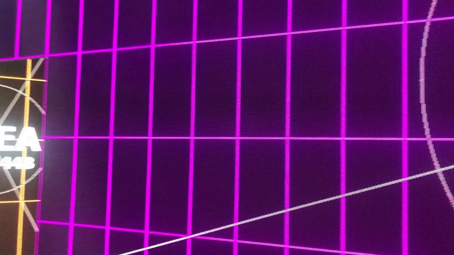 Close view of magenta LED wall mapping grid and curved alignment marks