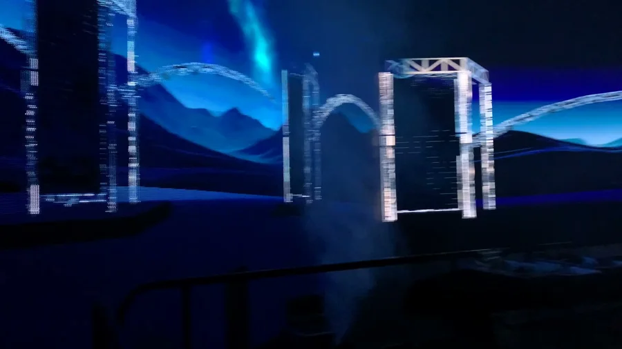 Side angle of the virtual stage showing arched lighting truss and landscape environment