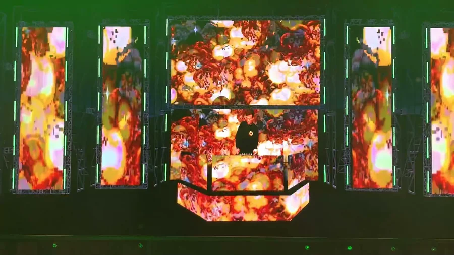 Virtual stage with fiery animated content across the DJ booth and LED towers