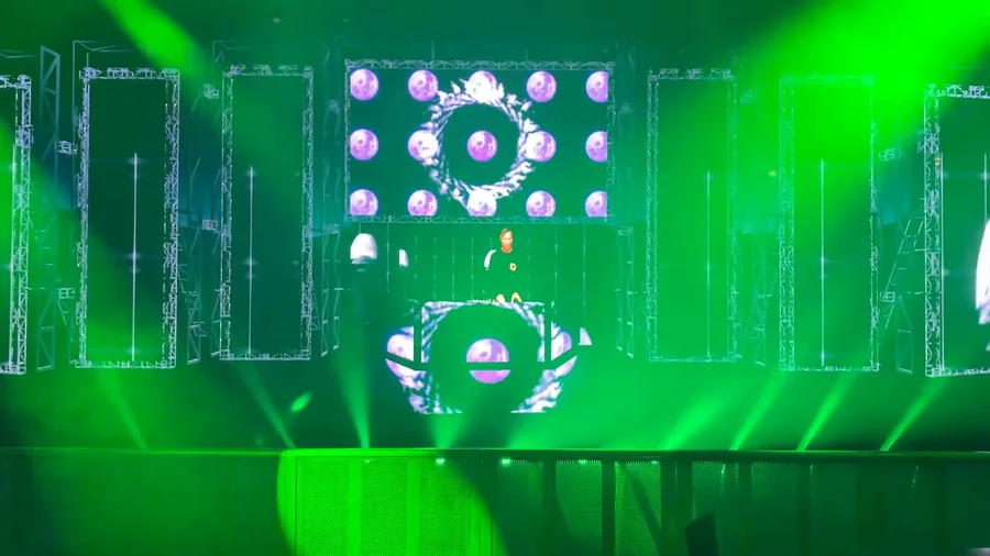 Wide front angle of the virtual stage with green lasers and central animated DJ booth