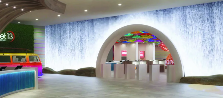 Wide view of the Planet 13 lobby with waterfall LED wall and themed VW van