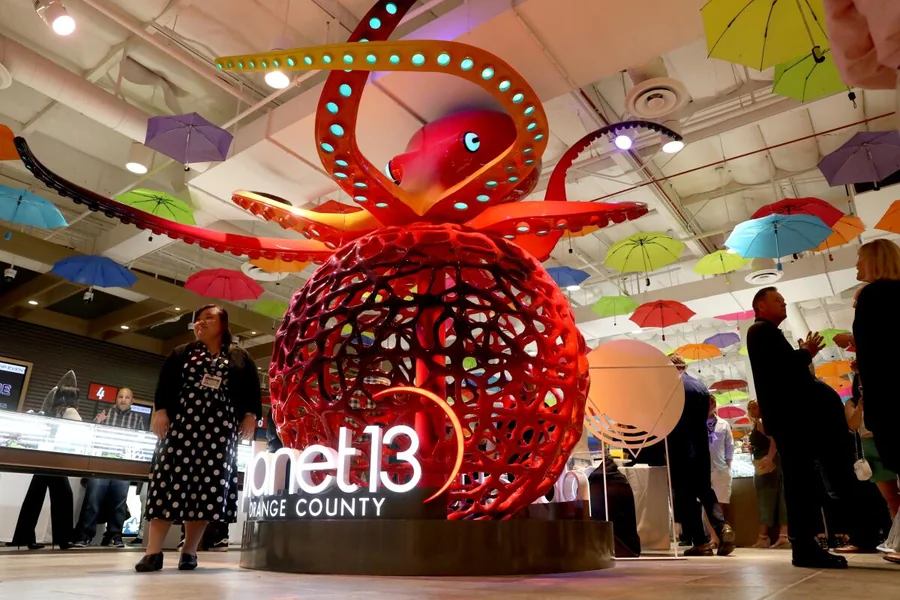 Large red octopus sculpture inside Planet 13 Orange County during the opening event
