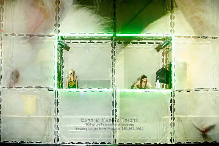 Close view of performers framed by the Tower of Babel scaffold bays