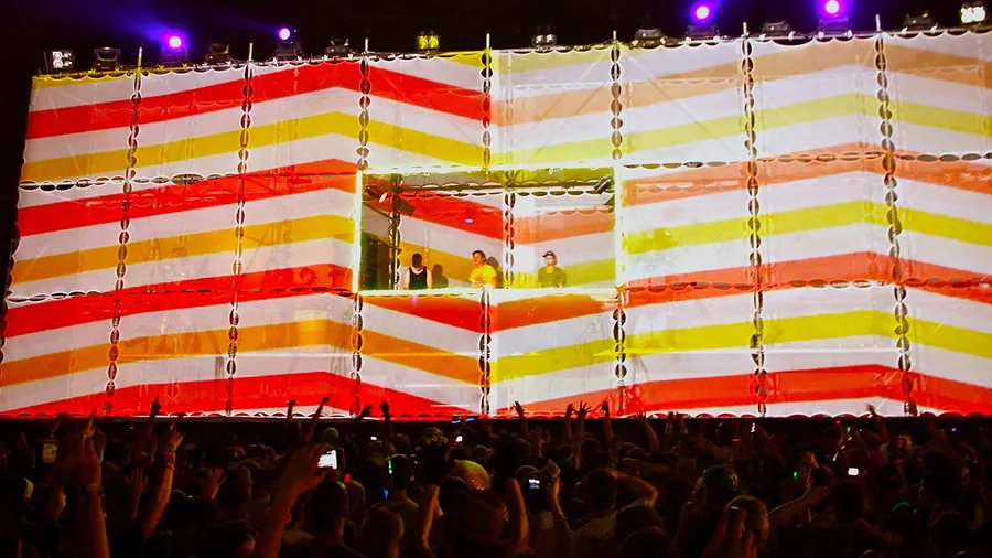 Striped live visuals across the Tower of Babel scaffold stage
