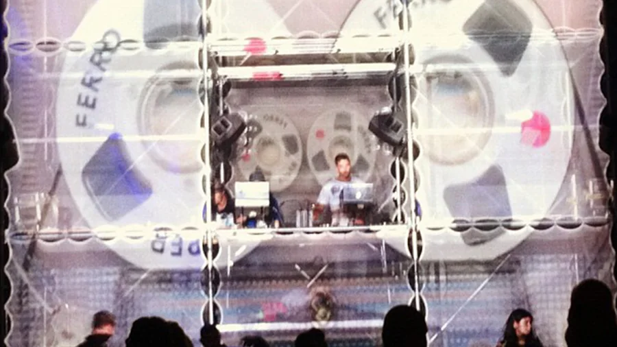 DJ booth centered inside the Tower of Babel projection surface