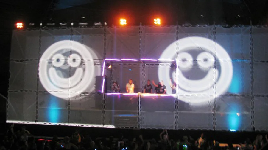 Graphic character visuals mapped across the Tower of Babel stage