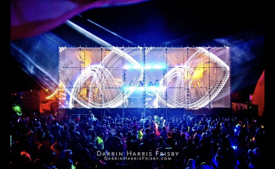 Wide night view of the Tower of Babel stage with spiral visuals projected above the crowd