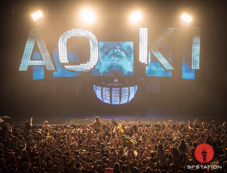 Wide view of the Aokify America stage with illuminated AOKI letters and a packed audience