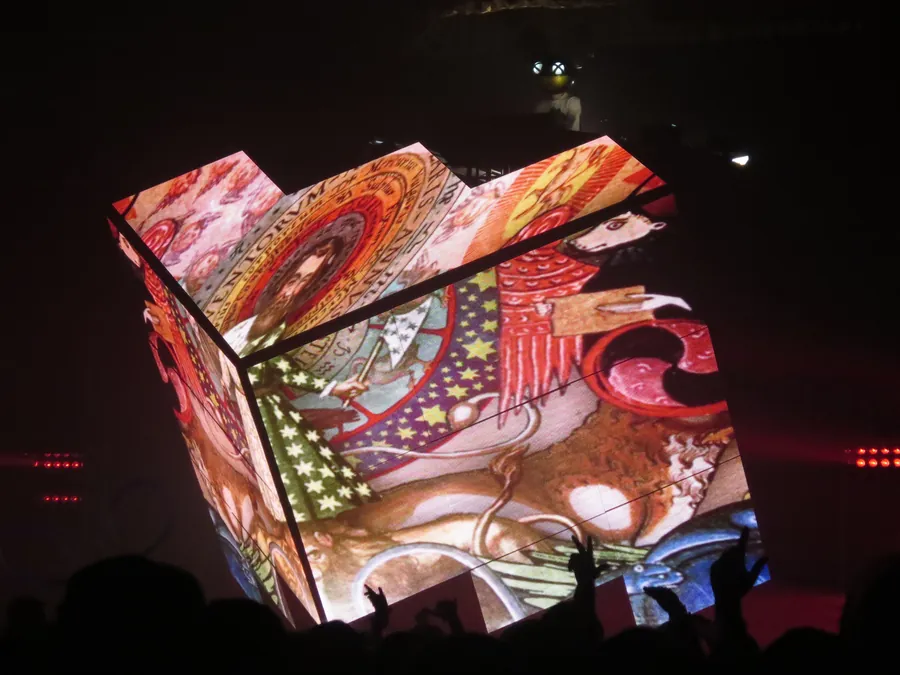 Cube 2.1 displaying illustrated organic visuals above the audience