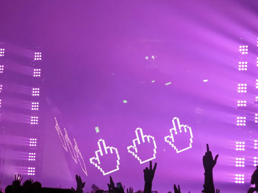 Purple Cube 2.1 show environment with silhouetted hands in the audience