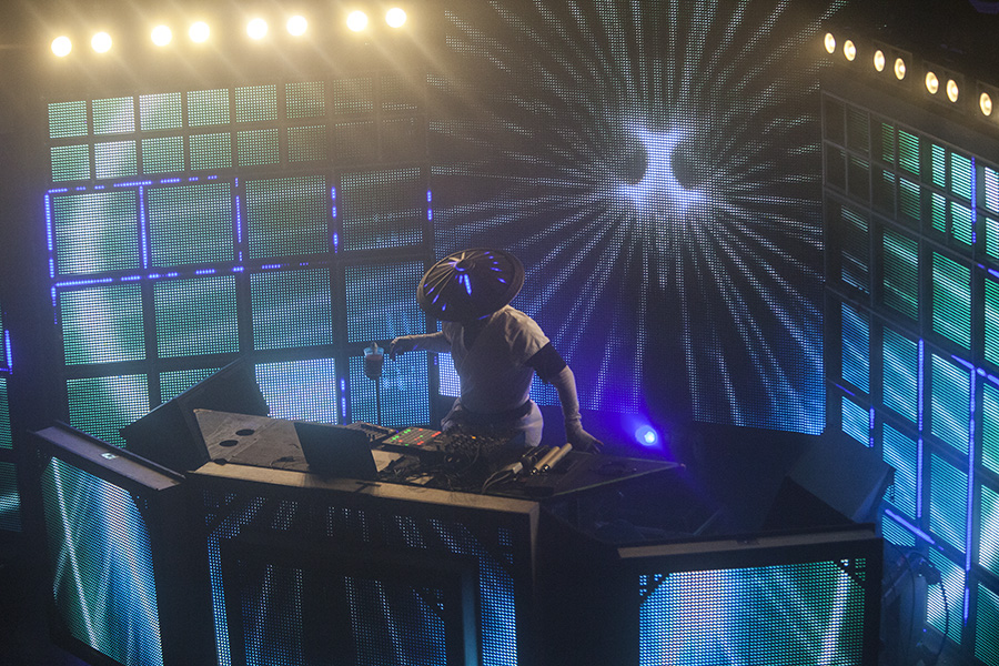Datsik performing at the Shogun LED booth against blue radial starburst visuals