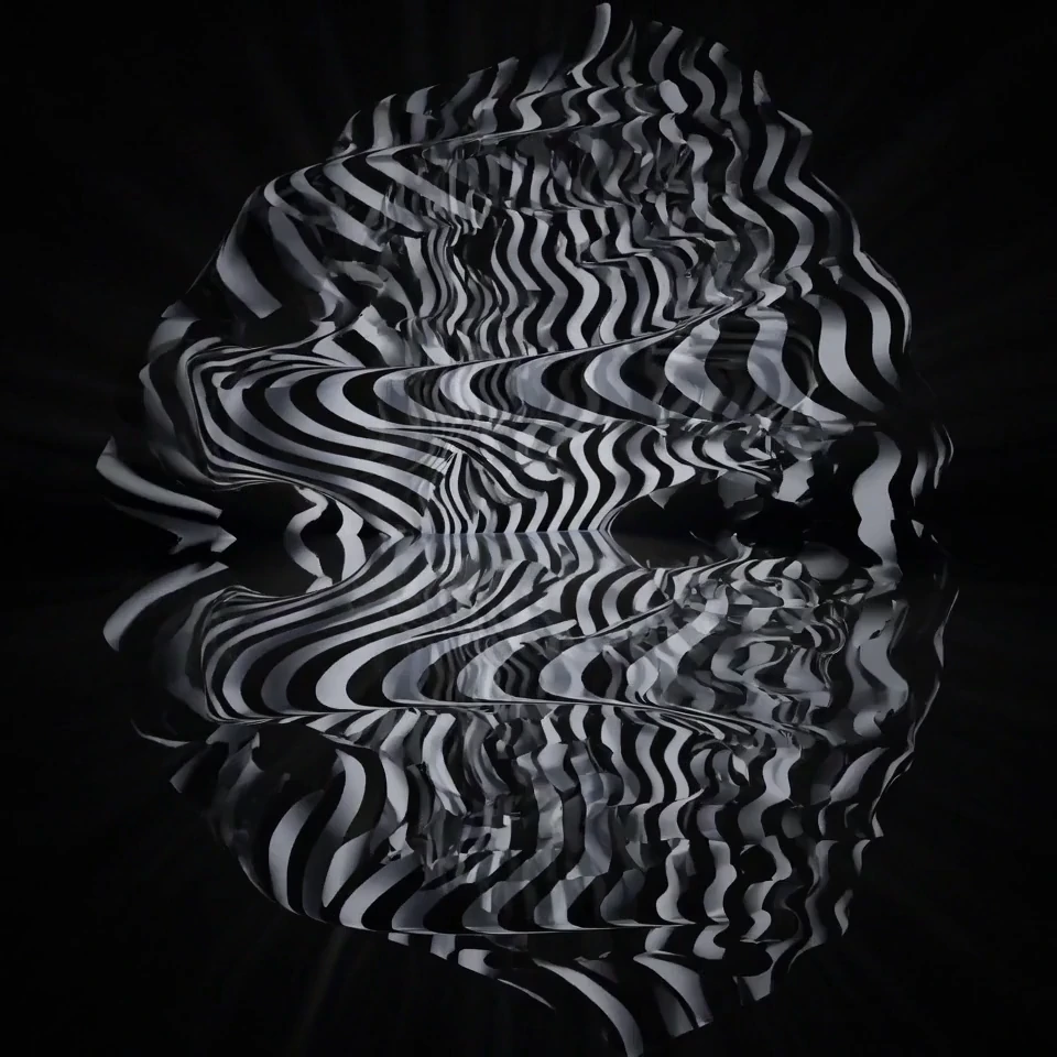 A rounded black-and-white striped sculpture on black.