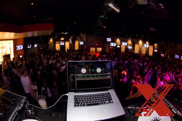 Packed XTREME crowd seen from behind a laptop at the live visual performance position