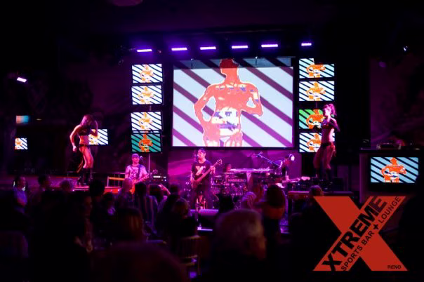 XTREME nightclub stage with live band, go-go dancers and multi-screen visuals