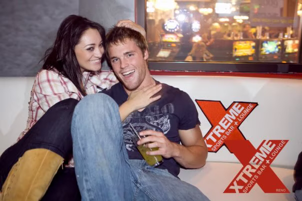 Guests seated in the XTREME lounge beneath the venue's screens